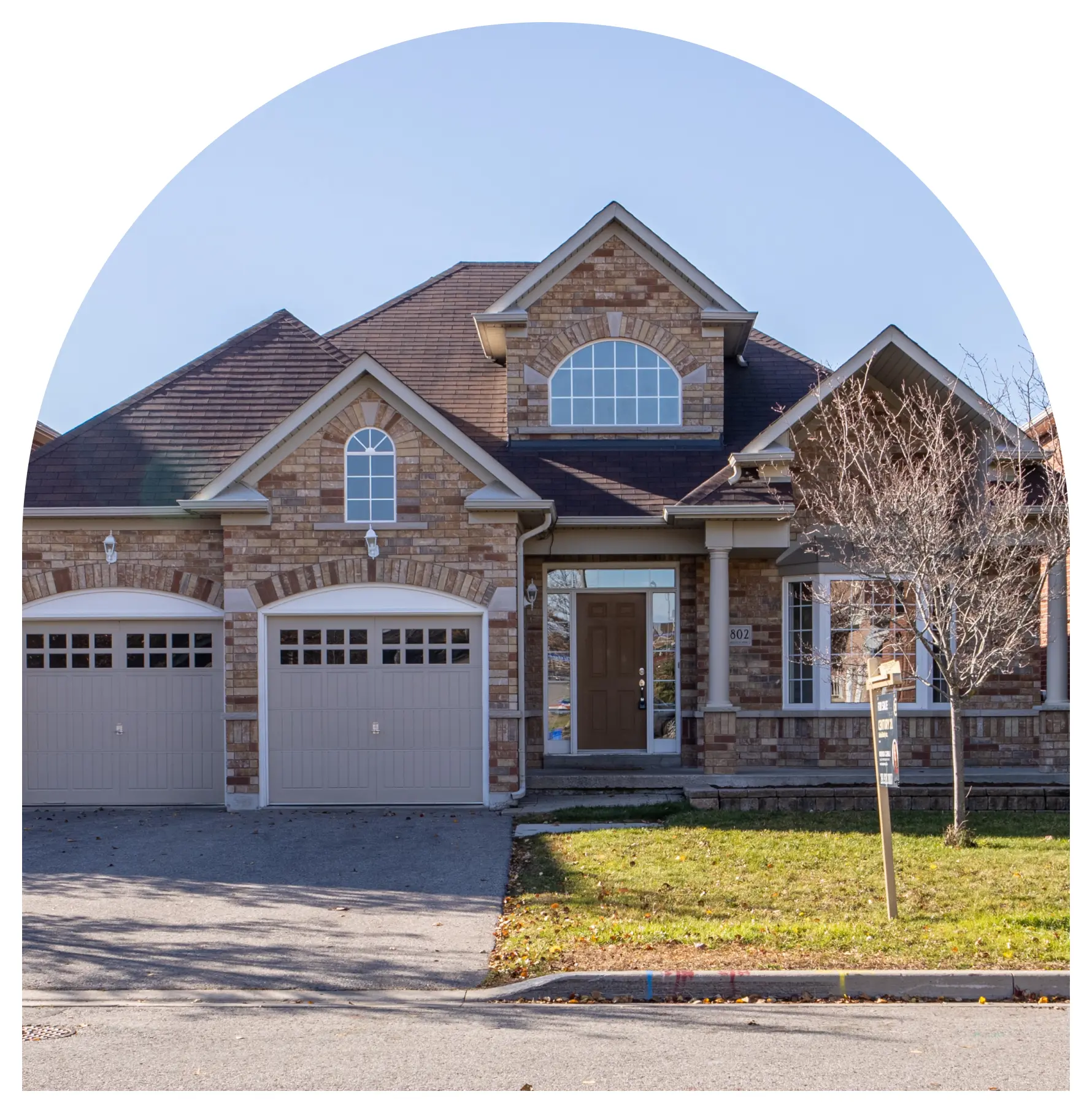 A house with two garage doors and a driveway.